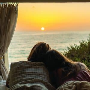 A,Couple,Is,Seen,Embracing,In,A,Cozy,Van,Bed